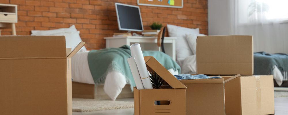 Cardboard boxes in dorm room on moving day